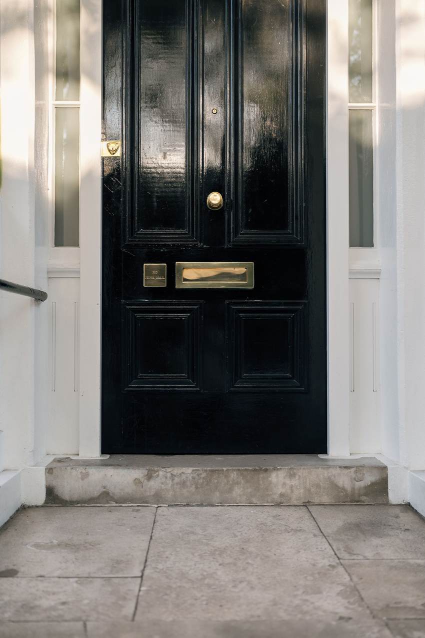 Glossy black front door with white trim